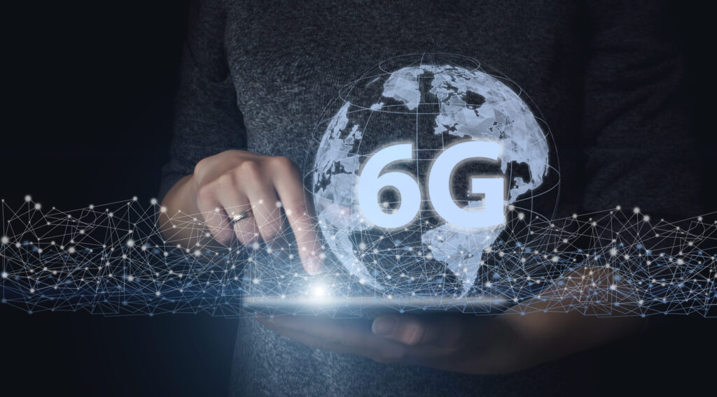 hand-hold-tablet-with-gologram-eart-and-6g-creative-connection-background-a-new-generation-network-has-a-wireless-speed-limit-mixed-media-6g-network-wireless-systems-futuristic-concept