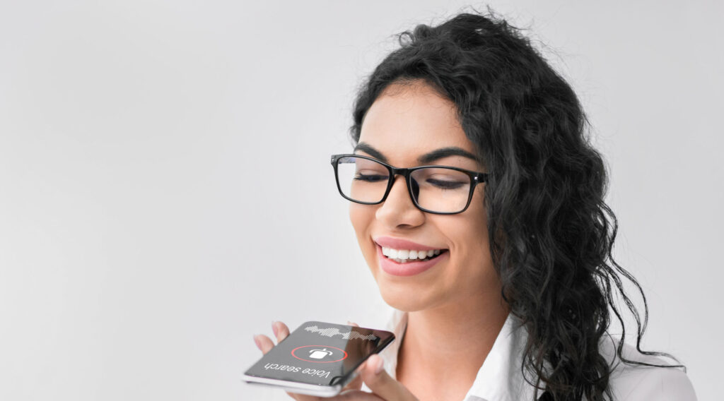 mexican-businesswoman-using-smartphone-voice-search-app-at-workplace-indoor